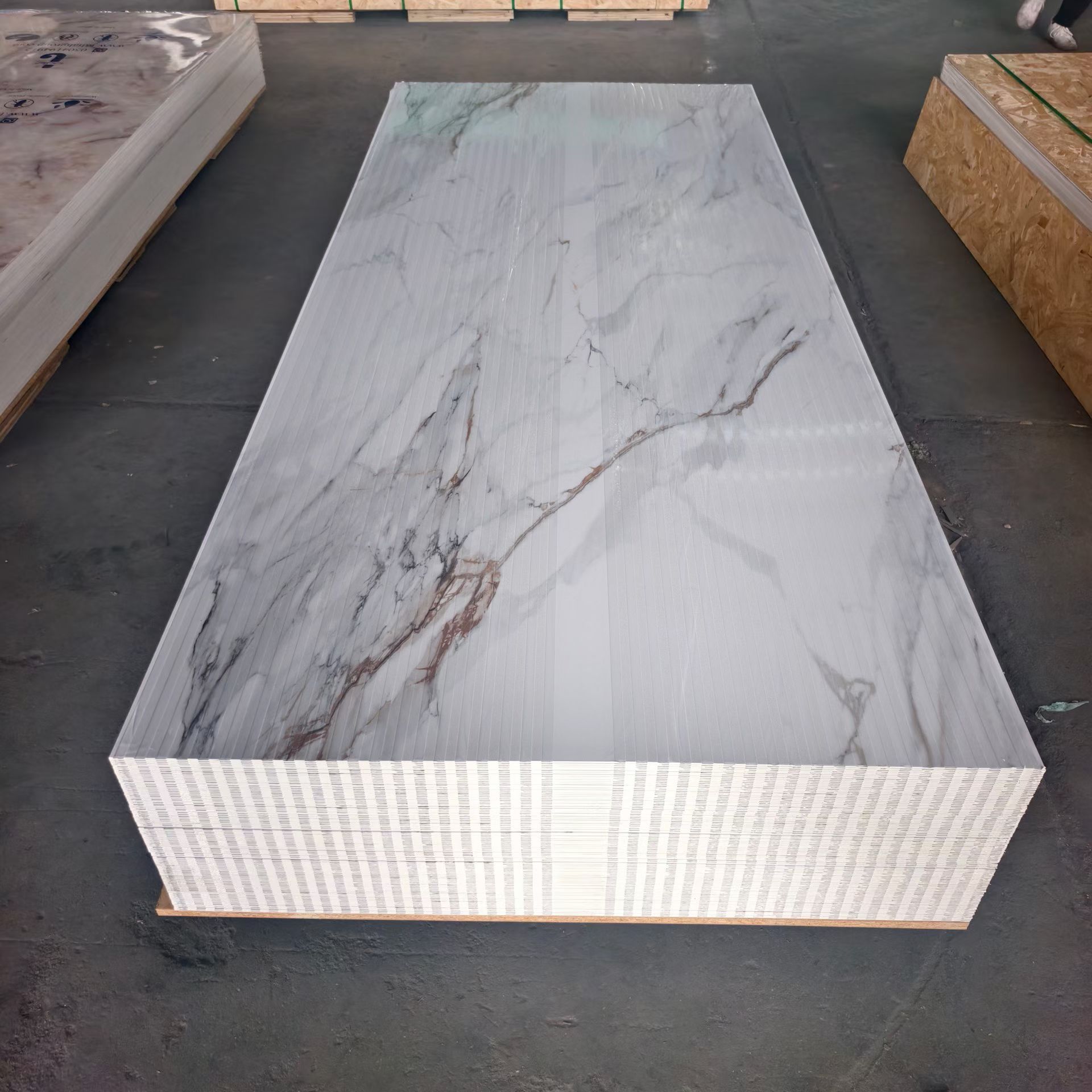 Finished Sheet Stock Marble-pattern UV sheets stacked and protected for storage and shipment by Home Plus Materials