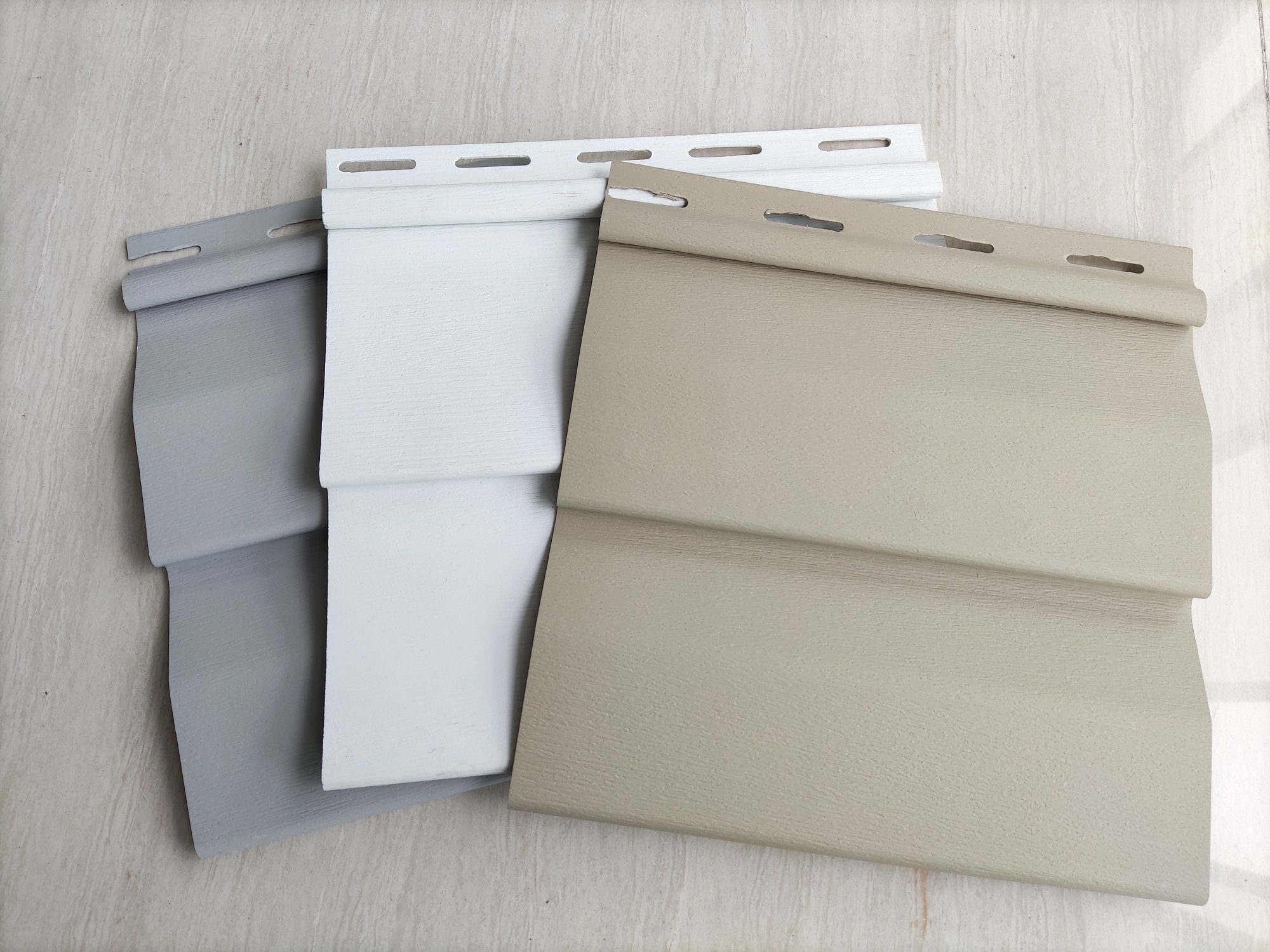 Pure Colour Collection White, grey and warm neutral siding colour options with a subtle wood-grain surface by Home Plus Materials